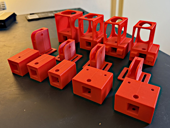 3D printed parts iterating towards a better design.